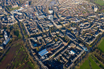 Wall Mural - Aerial photo of the town centre of Harrogate in the UK showing a muddy playing field known as the west park stray slammed as an environmental disaster after cars ruined the fields in the winter