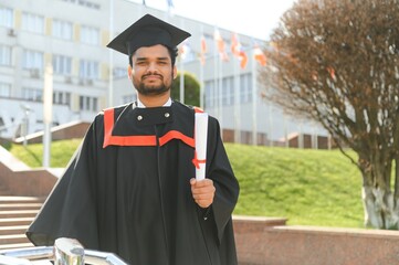 Wall Mural - Portrait of happy man, graduation or student in university campus