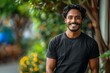 © Umme - Vibrant Outdoor Portrait of Smiling Indian Man in Stylish Black T-Shirt Mockup, copy space,
