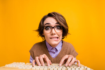 Photo portrait of attractive young woman type keyboard nervous bite lips dressed retro office clothes isolated on yellow color background