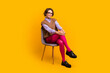 © deagreez - Photo portrait of attractive young woman sit chair confident pose dressed retro office clothes isolated on yellow color background