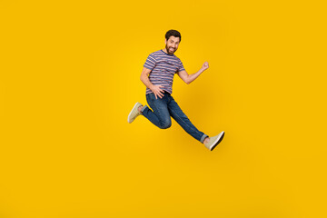 Sticker - Full length body photo of young adult bearded man jumping and loves playing guitar in air isolated over yellow color background