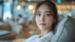 © 2D_Jungle - Korean beauty secretary in an ergonomic chair, customer rating data on a tablet