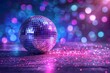 © volga - Sparkling disco ball with colorful bokeh background