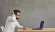 © Studio Romantic - Side view headshot of serious puzzled confused caucasian businessman executive manager looking at laptop scratching head thinking on received news sitting at desk against grey studio background