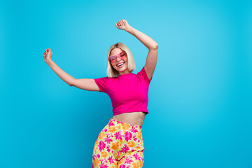 Poster - Photo portrait of lovely young lady touch sunglass summer dancing dressed stylish pink clothes isolated on blue color background