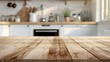 © Eduard Muzhevskyi - Close-up view of a wooden table top with a softly blurred kitchen background, highlighting a warm, inviting space. Product presentation backdrop