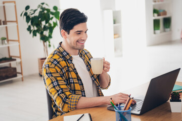 Poster - Photo of funky positive man wear checkered shirt communicating modern device drinking coffee house apartment room