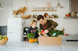 © Melissa Milis Photography/Stocksy - Family cooking a meal kit, home delivery