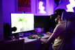 © Pixel Stories/Stocksy - Young adult gamer playing using VR headset on computer PC