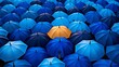 © Media Srock - Colorful umbrella standing out among blue umbrellas