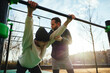 © BONNINSTUDIO/Stocksy - Father and son doing exercise on sports ground