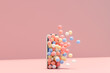 © Pixel Stories/Stocksy - 3D render of colorful balloons coming out of mobile phone