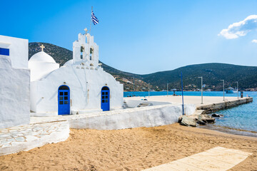 Wall Mural - Typical Greek white church on shore of sandy beach in Platis Gialos village, Sifnos island, Greece