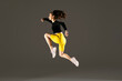 © BONNINSTUDIO/Stocksy - Woman jumping in studio