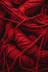 Aufkleber - A pile of red yarn on a black surface. Suitable for textile or craft concepts