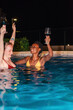 © Milles Studio/Stocksy - Happy women celebrating at night pool party