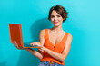 © deagreez - Photo of intelligent adorable woman with short hairdo dressed knitwear singlet holding laptop isolated on turquoise color background
