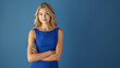 © overrust - blonde girl with folded arms in a tight blue dress