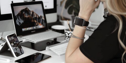 Fototapete - Modern Workspace with Laptop and Smartwatch, showcasing a tech-savvy environment for productivity and efficiency, highlighting digital tools and a stylish home office setup