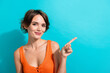 © deagreez - Photo of positive cheerful woman dressed knitwear singlet indicating at discount empty space isolated on turquoise color background