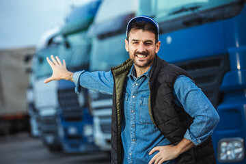 Wall Mural - Happy confident male driver standing in front on his truck