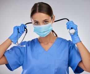 Poster - Mask, doctor and woman with stethoscope, studio and safety with gloves and PPE for healthcare. White background, medical and person with help, portrait and healthy in clinic and hands in hospital