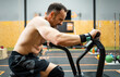 ©  Yistocking - A middle-aged man is working out inside a gym.The 50-year-old is working on strength and endurance with an air bike. Concepts of static air bikes.