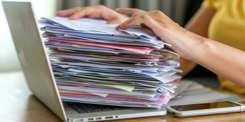 Aufkleber - Close-Up of Hands Managing Documents and Typing on a Laptop, Representing Productivity, Organization, and Professionalism in a Modern Workspace