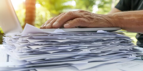 Aufkleber - Close-Up of Hands Managing Documents and Typing on a Laptop, Representing Productivity, Organization, and Professionalism in a Modern Workspace