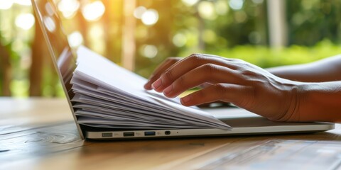 Aufkleber - Close-Up of Hands Managing Documents and Typing on a Laptop, Representing Productivity, Organization, and Professionalism in a Modern Workspace