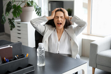 Poster - Young woman suffering from strong headache sitting in office