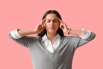 Sticker - Young woman suffering from headache on pink background