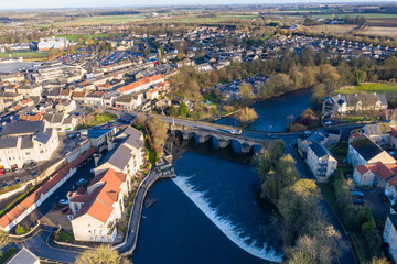 Wall Mural - Aerial photo of the town centre of Wetherby in West Yorkshire in the UK, showing the River Wharfe with traffic driving over the small bridge that leads in to the town centre, taken in the winter.
