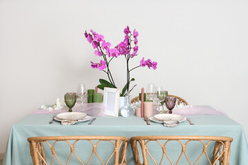 Sticker - Beautiful table setting with orchid flower for wedding celebration near light wall