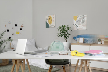 Canvas Print - Student's table with laptop and copybooks in bedroom