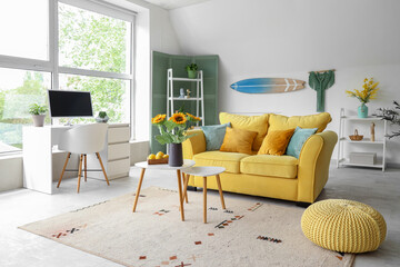 Wall Mural - Interior of stylish living room with sofa, workplace and hanging surfboard