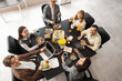© Pixel-Shot - Group of business people having lunch at table in office, top view