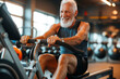 © MVProductions - Active senior man doing an exercise on a rowing machine in a gym