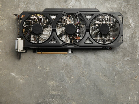 One graphics card on grey table, top view. Space for text