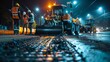 © Justlight - As the night sky glows with the city lights workers diligently work to complete the road paving project with a sense of pride and accomplishment.