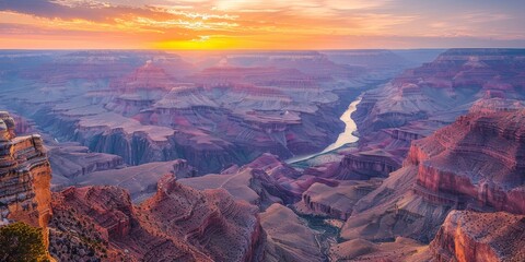 Wall Mural - Breathtaking sunrise view over the Grand Canyon National Park with vibrant colors and the Colorado River snaking through the stunning landscape.