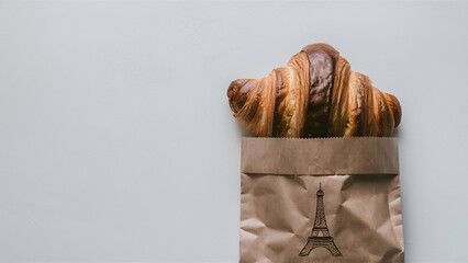 Wall Mural - Freshly baked French buttery flaky croissants in brown paper bag on white background. Minimalist creative food banner with copy space