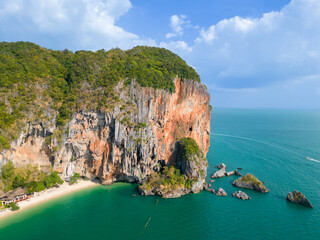 Wall Mural - Top aerial drone view of the beautiful Railay Beach in Thailand. Panoramic view of an idyllic beach with huge limestone cliffs from above, turquoise ocean, tropical island