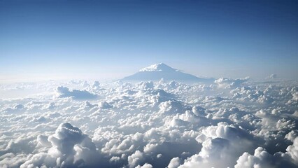 Wall Mural - a distant shadow appearing to defy gravity as it stands tall amidst the puffy white clouds.