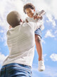 © peopleimages.com - Dad, boy and happy with lifting up in outdoor for playing, fun and bonding with love and care for child development. Black parent, kid and smile or laugh on break with support, comfort and safety