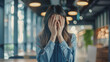 © Jarumas - The upset woman stood alone in the co-working space, covering her face with her hands, as she experienced work difficulties, emotions, and disappointment.