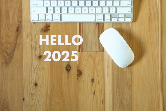 Hello 2025, words next to computer keyboard and mouse. New year concept.