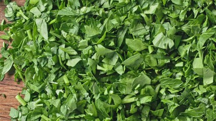 Sticker - Fresh green chopped parsley background, top view, movement to the side. Close-up of food