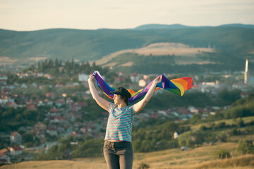 Wall Mural - Young woman with LGBT flag.